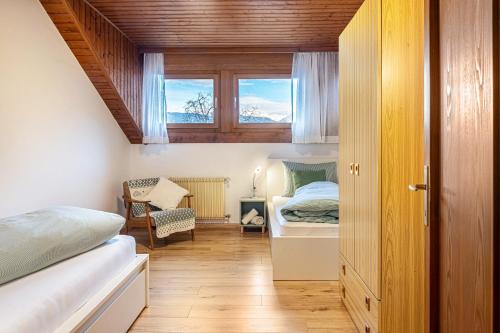 a small bedroom with a bed and a window at Villa Pinie Apt 1 in Terlano
