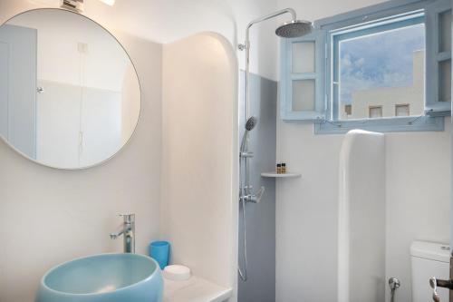 a bathroom with a blue sink and a mirror at Pico Bello Patmos 22 in Patmos