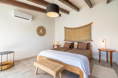a bedroom with a bed and a bench in a room at Finca Cas Forner in Islas Baleares
