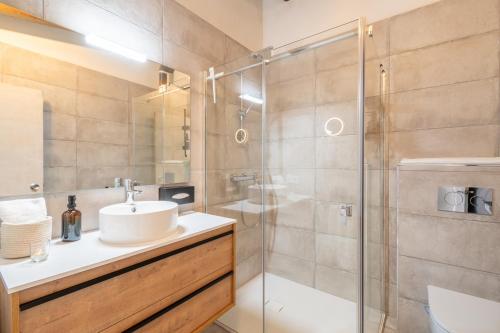 a bathroom with a sink and a glass shower at Finca Cas Forner in Islas Baleares