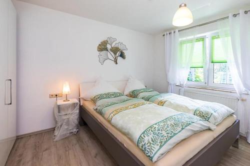 a bedroom with a bed with pillows and a window at Ferienwohnung Manns in Bettnau