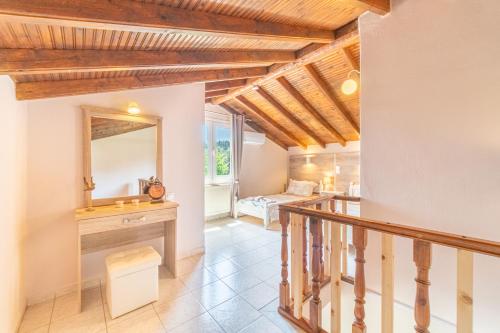 a hallway with a vanity and a mirror in a house at Villa Logas in Peroulades