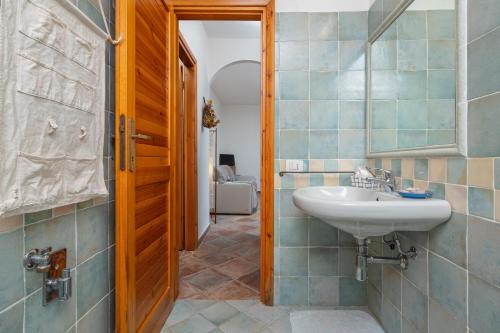 a bathroom with a sink and a mirror at Holiday house li Piri in San Teodoro
