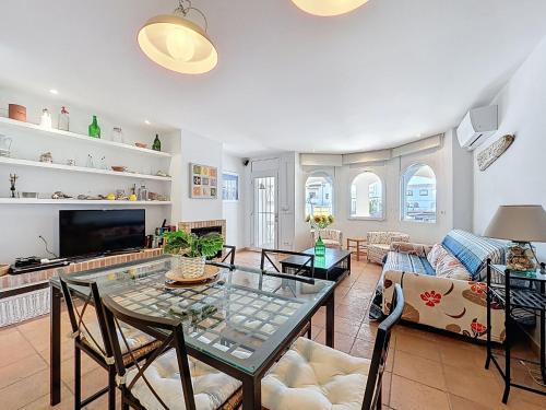 a living room with a glass table and chairs at Holiday Home Salins by Interhome in Empuriabrava