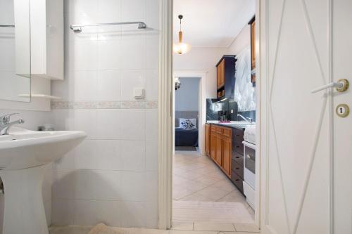 a bathroom with a sink and a toilet and a shower at Olympia Holiday Home in Zakynthos