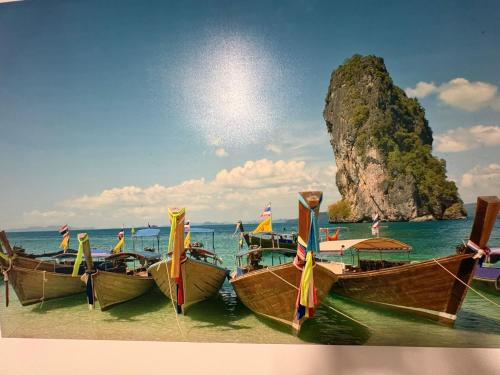 three boats on the beach with a rock in the background at Rincon del puerto I in A Guarda