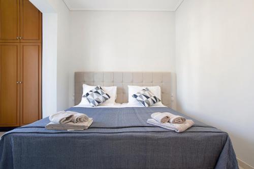 a bedroom with a bed with towels on it at Olympia Holiday Home in Zakynthos