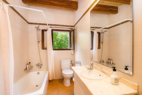 a bathroom with a sink and a tub and a toilet at Can Company in Campanet