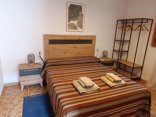 a bedroom with a bed with two towels on it at Antiga escola de Molinell in Culla