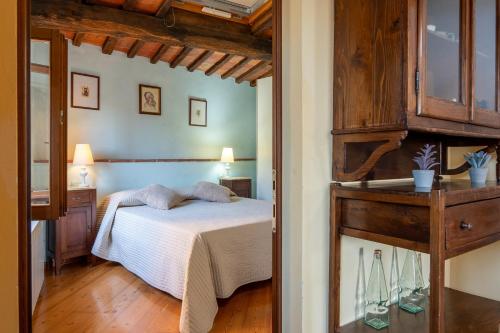a bedroom with a white bed and a mirror at Small Rustic Apartment in Scrofiano