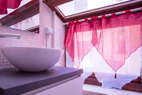 a bathroom with a sink and a bowl on a counter at B&B Pedruzza in Alghero