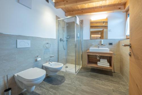 a bathroom with a toilet and a sink and a shower at App. Erta - Ciasa Lavarella in San Vigilio Di Marebbe
