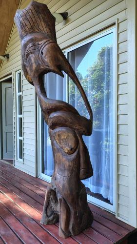 a statue on the porch of a house at Mai 'Uta Experience in Hanga Roa