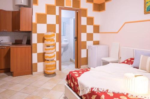 a room with a bed and a sink and a bathroom at B&B Pedruzza in Alghero