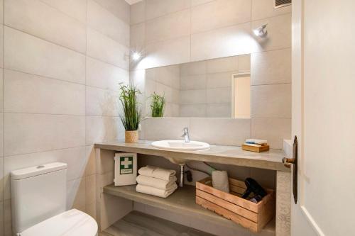 a bathroom with a sink and a toilet at Âncora B in Monte Gordo