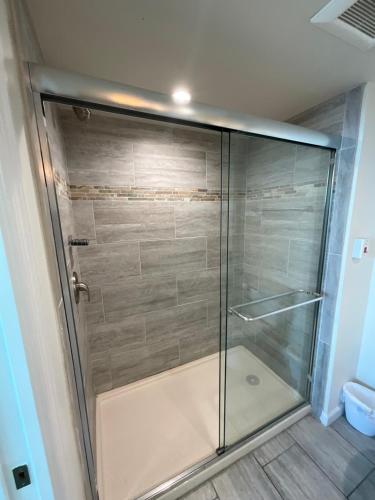 a shower with a glass door in a bathroom at Stunning Water View Suite in Fort Myers