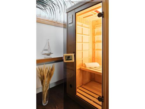 a room with a closet with a glass door at Ferienhaus am Millibach in Wehingen