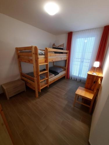 a bedroom with two bunk beds and a window at Ferienhaus Emelie Geiseltalsee in Mücheln