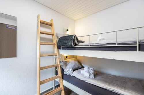 a room with two bunk beds and a ladder at Fewo Luzia in Schönwald