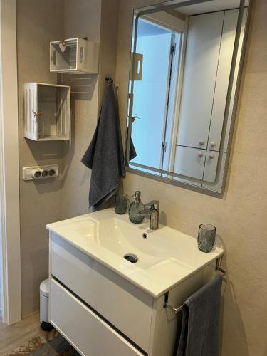 a bathroom with a sink and a mirror at Costa Brava beach studio in Sant Antoni de Calonge