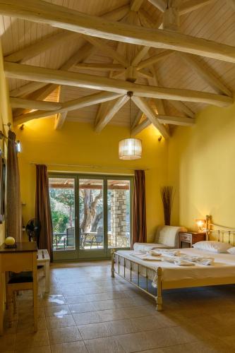 a bedroom with a large bed with a wooden ceiling at Menagia Village in Agios Georgios