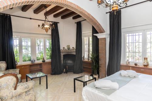 a living room with a bed and a fireplace at Espacio Rural La Cabaña de Miraflores in Miraflores de la Sierra