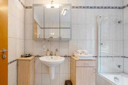 a white bathroom with a sink and a shower at Bei Annemarie in Trier