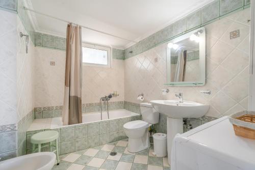 a bathroom with a sink and a toilet and a tub at Villa sea view 1 in Athani