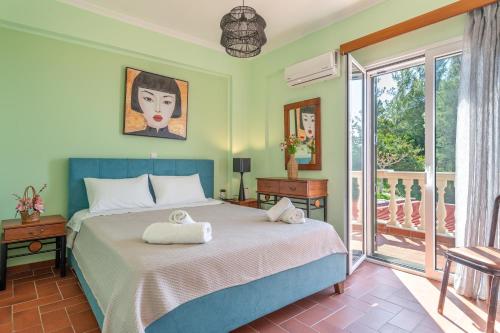 a bedroom with a bed and a balcony at Villa sea view 1 in Athani