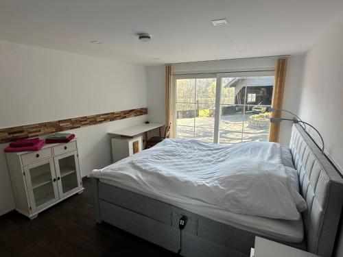 a bedroom with a bed and a window at Bergisch Resort Josef in Lindlar
