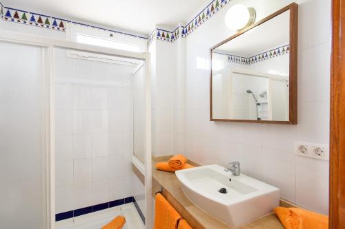 a white bathroom with a sink and a mirror at Luis ii in Puerto del Carmen
