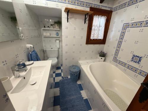 a bathroom with a tub and a sink and a toilet at Casa Trinidad in Denia
