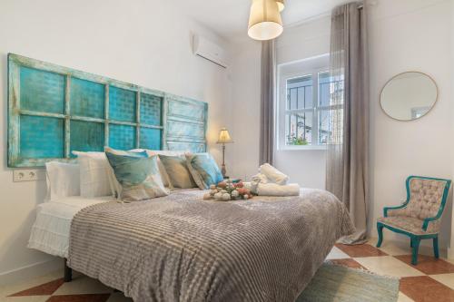 a bedroom with a bed with a bowl of fruit on it at Barsanz Palace Home in Alcalá del Valle