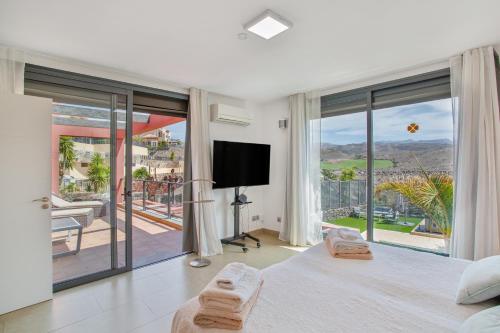 a bedroom with a large bed and a large window at Alexandria's Retreat in San Bartolomé