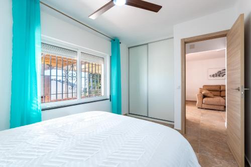 a bedroom with a bed and a window at Casa Pepe junto al mar in Benajarafe