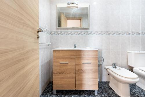 a bathroom with a sink and a toilet and a mirror at Casa Pepe junto al mar in Benajarafe
