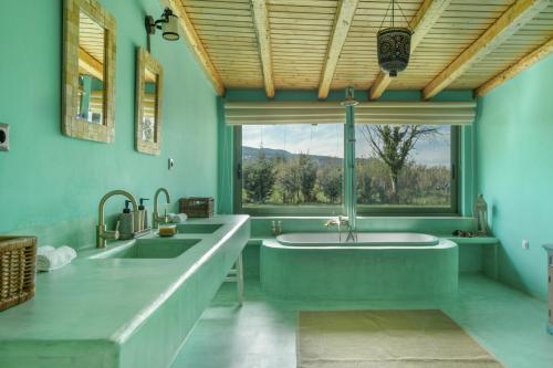 a bathroom with two sinks and a large tub at Lefkadas Bohemian Cottage in Lefkada