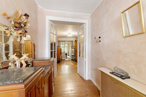 a large kitchen with a sink and a mirror at La Belle Gabarre in Groléjac