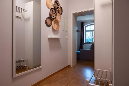 a hallway with a mirror and plates on the wall at Ferienwohnung Lindner 2 in Weimar