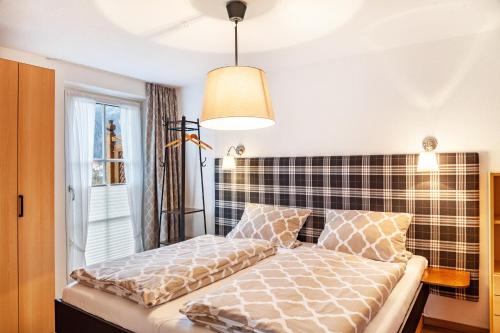 a bed in a room with a window at Ferienwohnung Zugspitzblick in Farchant