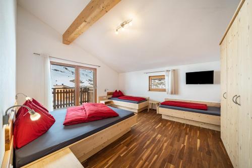 a large room with two beds and a window at Seppnerhof Ferienwohnung Edelweiss in Moso
