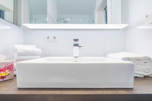 a bathroom with a white sink and a mirror at Appartement Halbinsel Wittow in Binz
