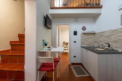 a kitchen with a counter and a red stool at Sg Apartment Standard in Massafra