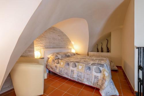 a bedroom with a bed and a stone wall at Sg Apartment Standard in Massafra