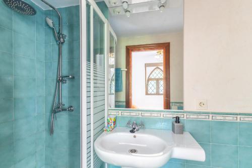 a bathroom with a sink and a shower with a mirror at Isla Del Burguillo in Ávila