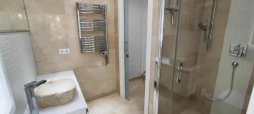 a bathroom with a shower and a sink and a toilet at Beach House El Saladillo in Estepona