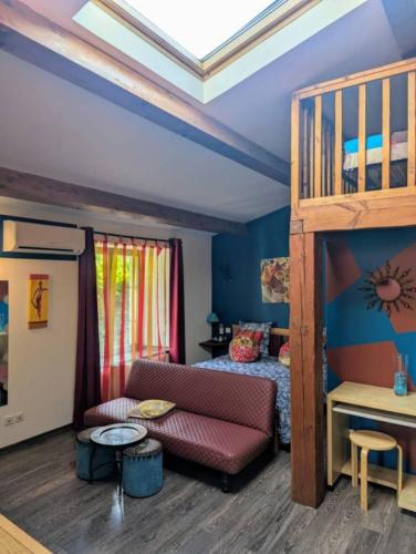 a living room with a couch and a bunk bed at Chambres D'hôtes - Au Soleilo in Mostuéjouls