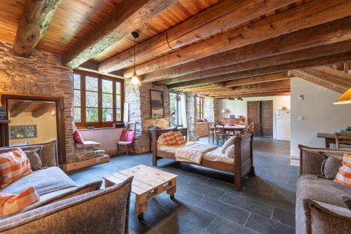a living room with couches and a table at La Ketzerie à Adervielle in Adervielle