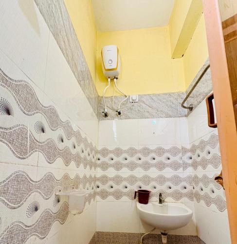 a bathroom with a sink and a toilet at MSN-Gate1Temple in Srikalahasti