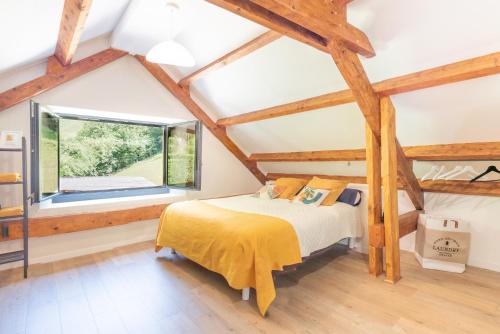 a bedroom with a bed and a large window at Gîte Lodge L'authentik in Accous